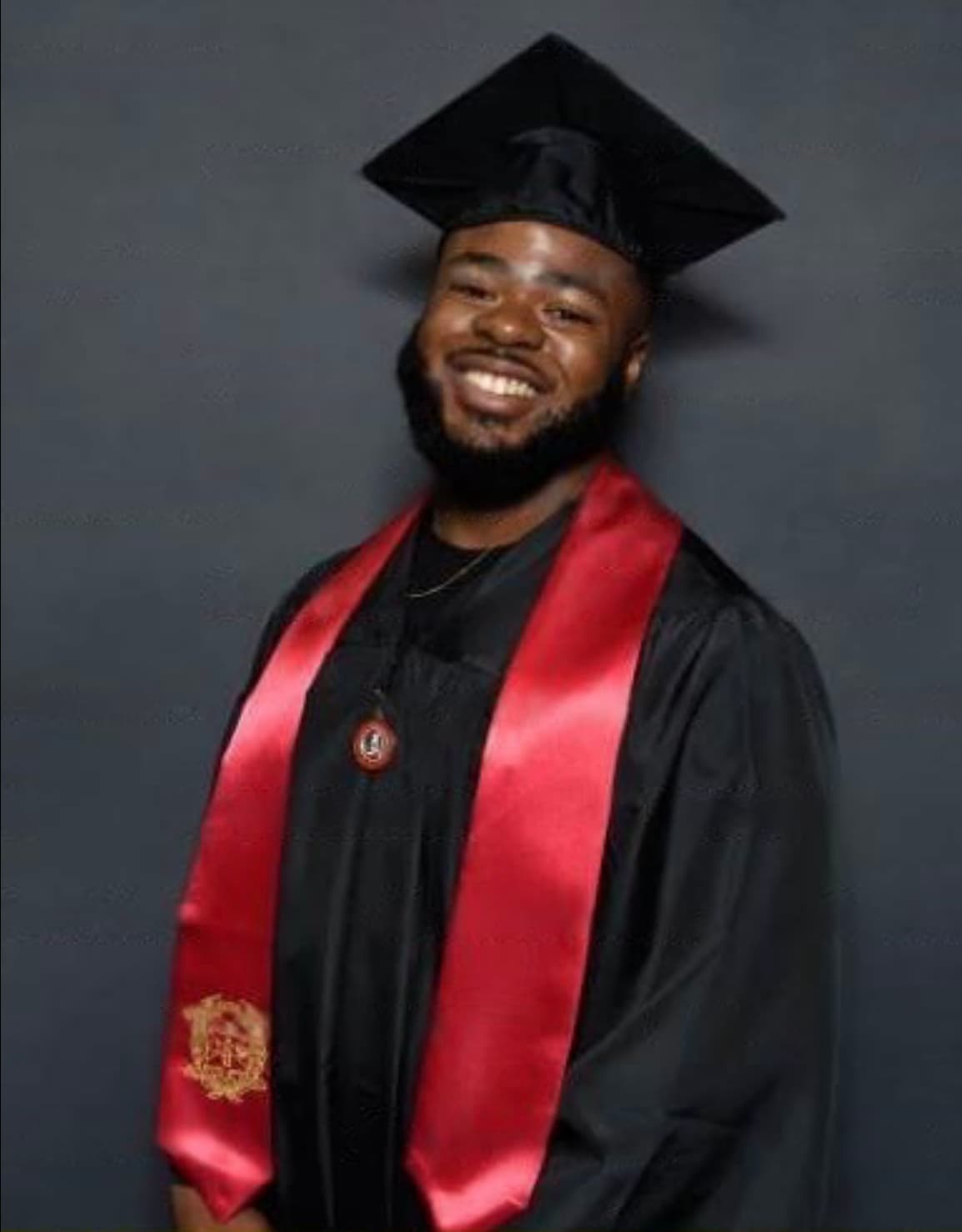 Bernard Ginn Jr. in graduation regalia